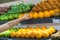 Fresh healthy fruits on shelves in supermarket. With a woman hand choosing best fruits