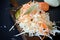 Fresh healthy salad - cabbage, carrot Coleslaw on a wooden board on a light background. Vegetables for ferment