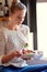 Fresh, healthy and sooo good. Shot of a young woman eating a healthy salad in her kitchen.