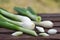 Fresh healthy spring onions on wooden table