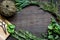 Fresh herb frame on dark wooden background top view