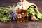 Fresh herbs from the garden and the different types of oils for massage and aromatherapy on table with lavender