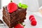 Fresh home made sticky chocolate fudge cake with strawberries and raspberries