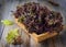 Fresh homegrown purple lettuce in basket on wooden table