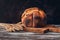 Fresh homemade bread with a crispy crust on a wooden rustic table with ripe wheat ears. Selective focus