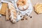 Fresh homemade bread and various pastries on a brown background top view.