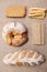 Fresh homemade bread and various pastries on a brown background top view.