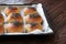 Fresh homemade burger buns with poppy seed, concept of burger and homemade food. Mini challah. Homemade bread on paper and tray on