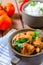 Fresh homemade chicken curry with chilly in vintage ceramic bowl. Selective focus