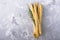 Fresh homemade crispy bread sticks with thyme and sea salt on a gray concrete background herbs. selective focus