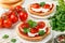 Fresh homemade crispy bruschetta with baked tomatoes cherry, cream cheese ricotta, red sauce and parsley cilantro Square pictu