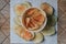 Fresh homemade deep fried crispy potato chips in white box on a wooden background, top view. Salty crisps scattered on a table for