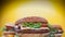 Fresh homemade grilled burgers rotating on yellow background. Meat patty, tomatoes, cucumber, lettuce and sesame seeds