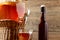 Fresh homemade Kombucha fermented tea drink in jar with faucet and in cup and bottle on wooden background