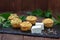 Fresh homemade muffins with cheese and nettle on wooden table