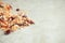 Fresh homemade organic crispy muesli with nuts and berries on a beige background, close up with free space.