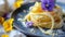 Fresh homemade pasta tagliatelle with edible flowers on a ceramic plate