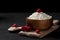 Fresh homemade pure cottage cheese in a wooden plate with raspberries in a rustic bowl against a dark background, healthy food on
