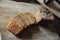 Fresh homemade unleavened bread on the leaven is sliced on a wooden board. Serving of breakfast