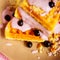 Fresh homemade Viennese waffles, drenched with yogurt and berries