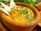 Fresh hummus, greens appetizer on a wooden background vegetarian