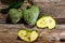 Fresh hybrid fruit of atemoia Annona cherimolia Mill x Annona squamosa L. in matedes on wooden background