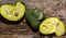 Fresh hybrid fruit of atemoia Annona cherimolia Mill x Annona squamosa L. in matedes on wooden background
