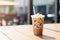 Fresh iced latte coffee on wooden table. Summer drink