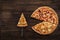 Fresh italian pizza and a pie spatula with one slice on the wooden background. Top view and copy space for text