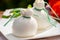 Fresh italian soft cheese burrata or burratina served on outdoor terrace in sunny day