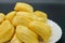 Fresh jackfruit slices on a white plate. sweet yellow jackfruit ripe. vegetarian, vegan, raw food. Exotic tropical fruit - closeup