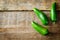 Fresh jalapeno peppers on a dark wood background