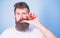 Fresh juice concept. Man drinks strawberry juice suck thumb as drink straw blue background. Hipster bearded holds