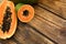 Fresh juicy cut papayas on wooden table