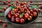 Fresh Juicy gooseberry in a black plate on wooden rustic table