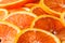 Fresh juicy orange fruit rings close up background.