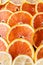 Fresh juicy orange and lemon fruit rings close up background.