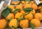 Fresh juicy oranges with green leaves in wooden boxes