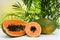 Fresh juicy papayas on white table against blurred background