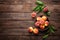 Fresh juicy peaches with leaves on dark wooden rustic background, above view