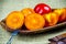 Fresh and juicy persimmon fruits on wooden plate