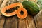 Fresh juicy ripe papayas on wooden table