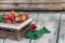 Fresh juicy strawberries with leaves. Rustic wooden box and handmade lace. Retro magazine picture. Strawberry with copy space
