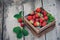 Fresh juicy strawberries with leaves. Rustic wooden box and handmade lace. Retro magazine picture. Strawberry with copy space