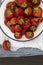 Fresh juicy strawberries on vintage enamelware crockery on rusti