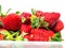 Fresh juicy strawberry in a plastic bag on a white background. Produce product of agriculture industry. Close up