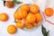 Fresh juicy tangerines on white tiled table, flat lay