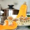 Fresh Khinkali or meat dumplings plate. Cut pumpkin and kitchen utensils on blurred background. Food concept. Square