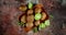 Fresh kiwi with leaves on wooden plate rotate slowly.