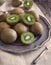 Fresh kiwis on vintage plate.